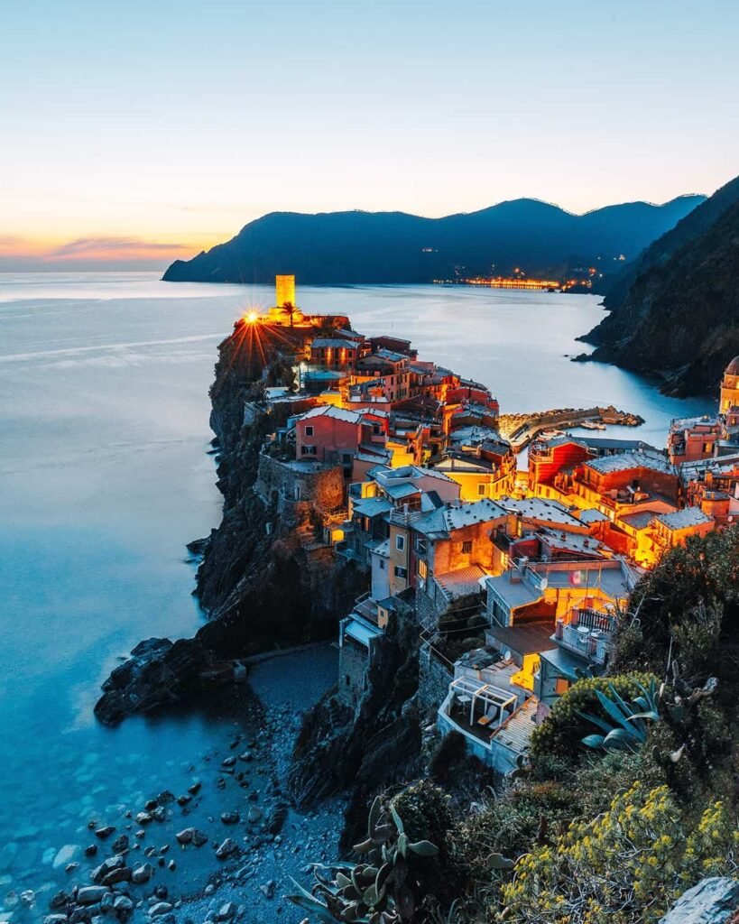 Coastal village illuminated at dusk.