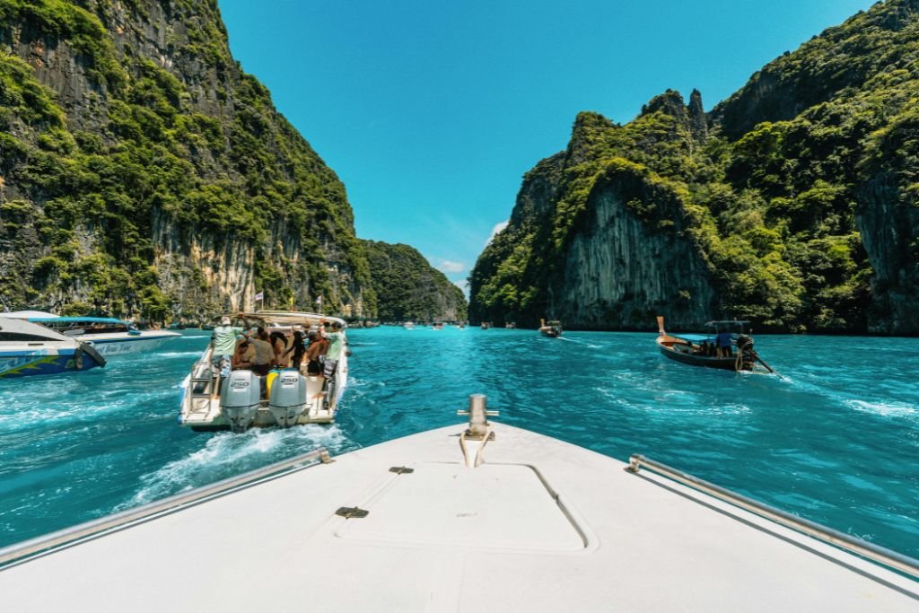 Boats navigating turquoise waters and cliffs, Thailand travel the great