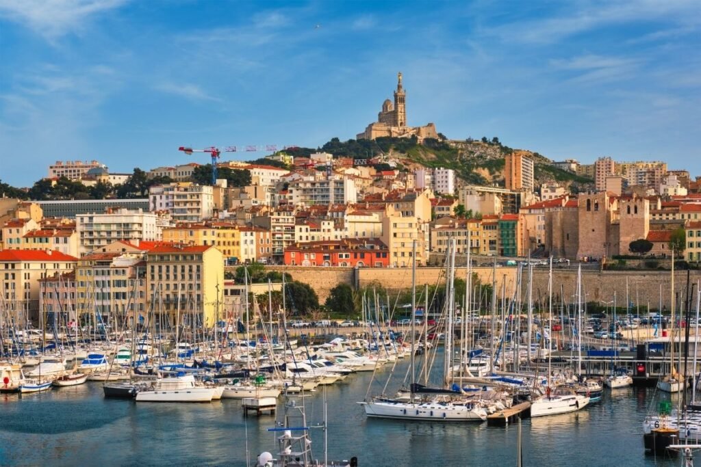 Harbor with boats and city skyline, France