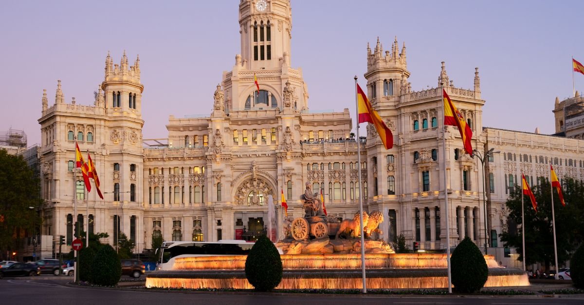Historic building with fountains and flags Spain