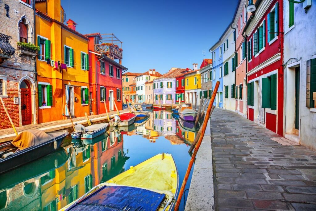 Colorful buildings along a serene canal. Italy